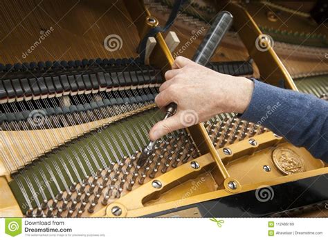 Hand And Tools Of Tuner Working On Grand Piano Stock Image Image Of
