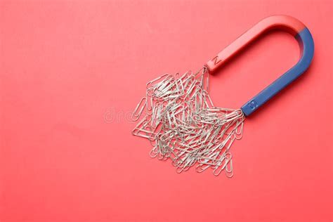 Magnet Attracting Paper Clips On Color Background Top View Stock Image