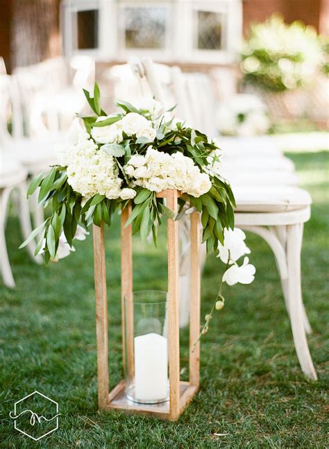 Natural Wooden Floor Lanterns Line This Stunning Ceremony Aisle At