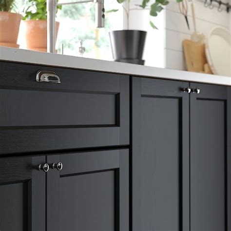 Cabinet refacing involves cosmetic changes like replacing kitchen cabinet doors and hardware or adding a wood veneer or layer of paint. A distinct traditional character in 2020 | Black ikea ...