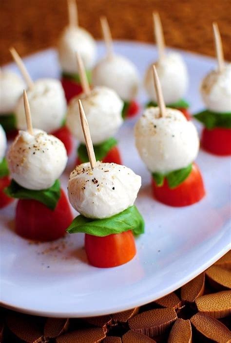 Small Appetizers With Toothpicks And Tomatoes On A White Plate Ready
