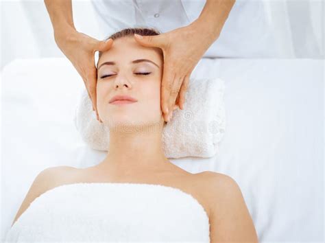 Young And Blonde Woman Enjoying Facial Massage In Spa Salon Beauty Concept Stock Image Image