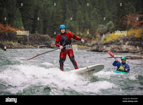 Two Adventurous Men Paddleboarding And Kayaking Down Snake River Hi Res