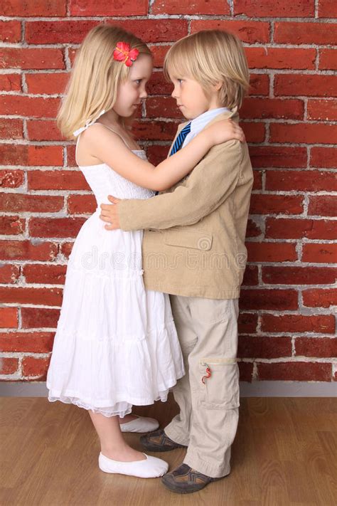 Little Boy Hugging A Beautiful Girl Stock Photo Image