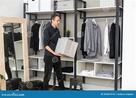 Portrait Of Handsome Office Worker Put Of Jacket In The Wardrobe Stock