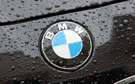 The Bmw Logo On A Black Car With Raindrops Wallpaper Download 5120x3200