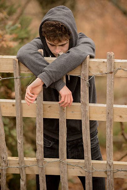 Sad Teenager Boy Crying Outdoors In Park Pictures Images And Stock