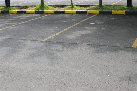 Parking Lots With Yellow Lane And Black And Yellow Sidewalk In A
