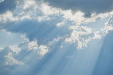 The Sun Shining Through The Clouds Against The Blue Sky Light Clouds