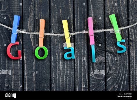 Goals Word Hanging On Clips And Wooden Wall Stock Photo Alamy