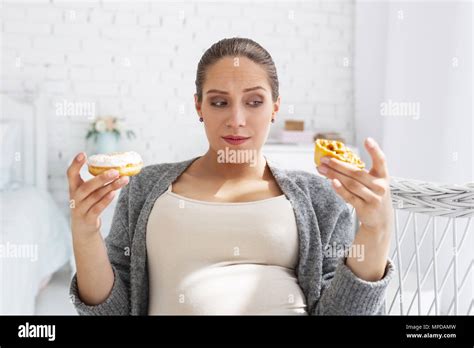 Pensive Pregnant Woman Selecting French Pastry Stock Photo Alamy