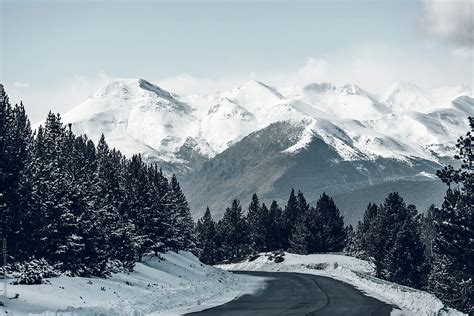Winter Road With A Snowy Mountains In The Background