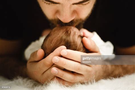 Father Kissing His Newborn Baby Girl High Res Stock Photo Getty Images