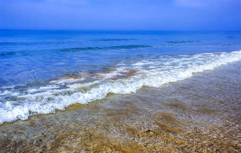 Coastal Waves Of Clear Blue Sea Water Beach Yellow And White Sand In
