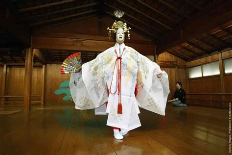 A Traditional Japanese Noh Actor Gets His Masks And Costumes Put On