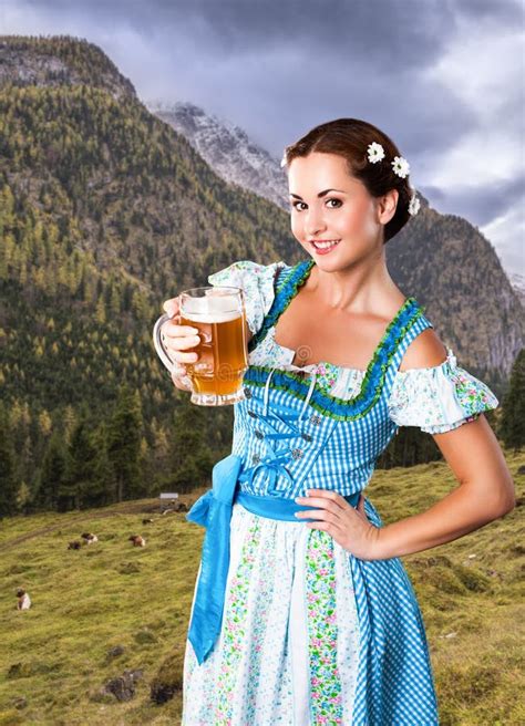 Beautiful Woman In A Traditional Bavarian Dirndl With A Beer Stock