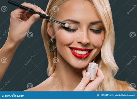 Beautiful Blonde Woman Applying Glamorous Makeup With Eyeshadows Stock