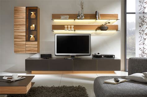 This image is ultra modern tv unit wall design and looks stunning. Use Natural Elements such as wood in your space. Versa ...