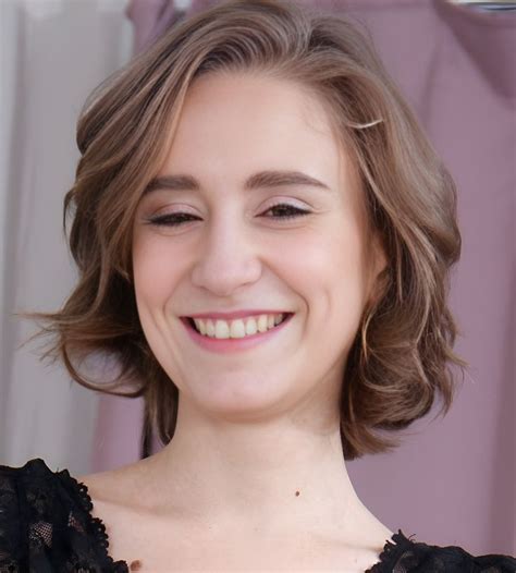 A Close Up Of A Person With A Smile On Their Face And Wearing A Black Dress
