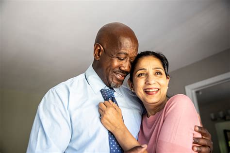 Mature Mixed Race Couple Getting Ready For Work Stock Photo Download