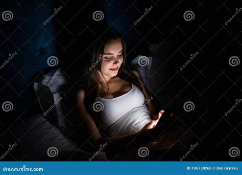 Young Woman On Bed Late At Night Texting Using Mobile Phone Sleepy And Tired In Internet