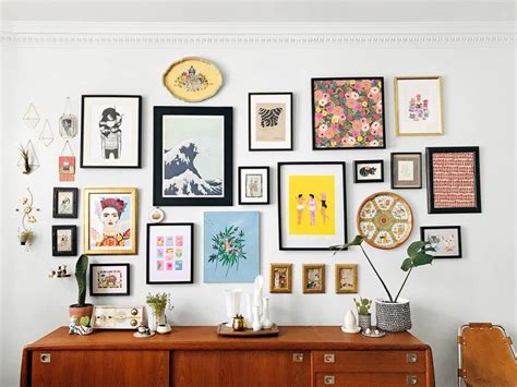 Gallery Wall An Assortment Of Art And Objects Hang On A Wall Above A