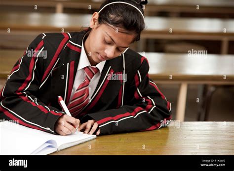 A Female High School Student Writing At Her Desk Stock Photo Alamy