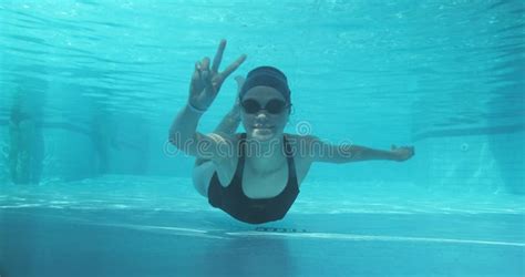 Athletic Teenager Girl Swimmer Underwater In Blue Outdoor Pool Looking