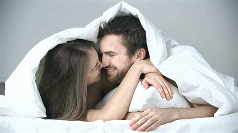 close-up-of-sweet-couple-cuddling-in-bed_4yglioe___F0000 - Wedding Affair