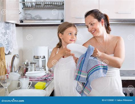 Smiling Little Girl Helping Mother Stock Image Image Of Clothes