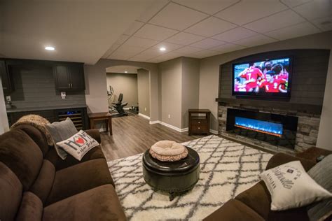 What's a living room without the perfect cozy couch to spend hours and hours on? Northville, MI Basement Remodel with Small Bar and Living ...
