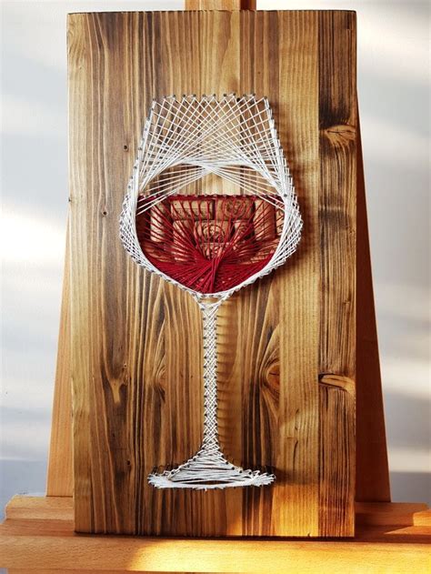 A Wine Glass Sitting On Top Of A Wooden Table Next To A Piece Of Wood