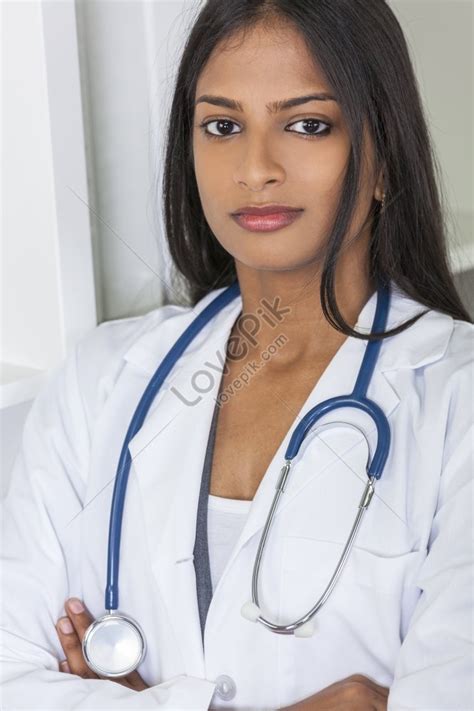 A Thoughtful Indian Asian Female Medical Doctor With Arms Folded And