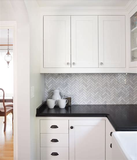White Kitchen Cabinets With Black Herringbone Backsplash
