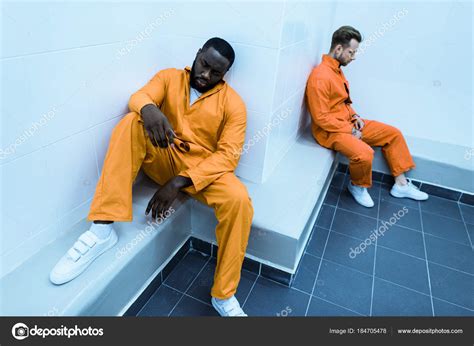High Angle View Multicultural Prisoners Sitting Benches Prison Cell