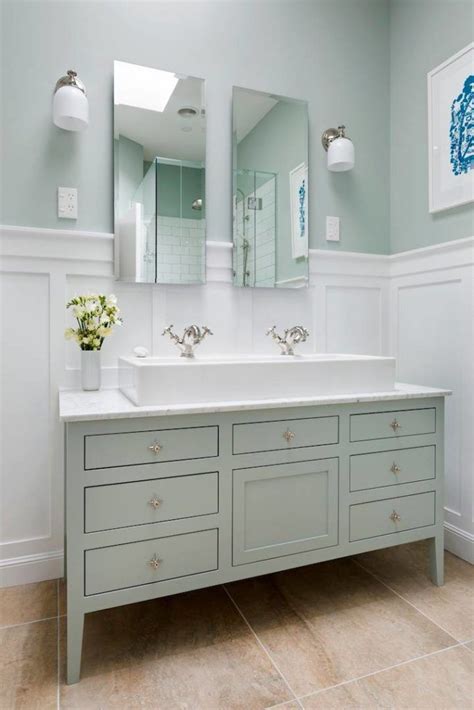 Traditionally, trough bathroom sinks are single basins but the definition has been expanded in recent years to include double basins. Main bathroom - One big sink with two faucets on a wood ...