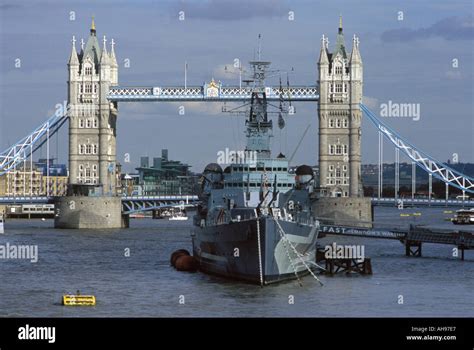 Hms Belfast On The River Thames In London With Tower Bridge In The