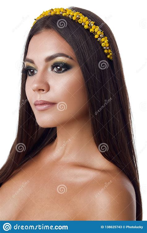 Portrait Of Beautiful Brunette Woman With Big Earring And Shinny Yellow Accessories In Hair