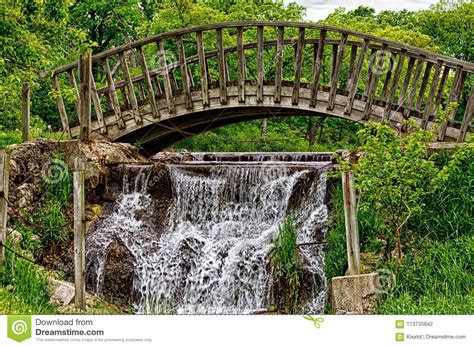 Wooden Bridge Over Flowing Water Stock Photo Image Of Waterfall