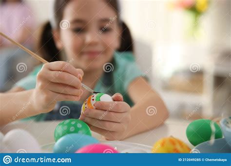 Little Girl Painting Easter Eggs At Table Indoors Focus On Hands Stock