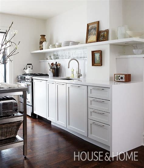 In This Kitchen A Long Open Shelf Holds Dishes And Is A Place To
