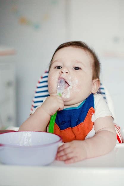 Premium Photo Little Baby Boy Eat Milk Porridge Baby In Cute Bib Eat