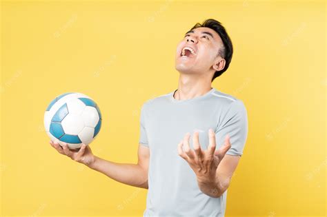Premium Photo Asian Man Holding Ball In Hand And Screaming