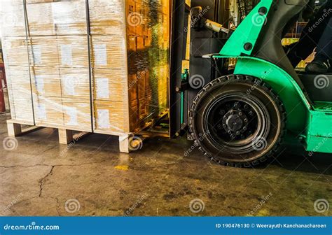 Worker Loading And Unloading Shipment Carton Boxes And Goods On Wooden Pallet By Forklift From