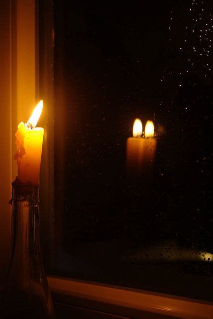 Reflection Of A Candle In The Window On A Rainy Night Window Candles