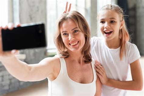 Free Photo Mother And Daughter Taking Funny Selfie