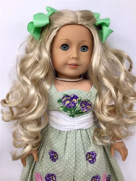 american girl doll ~ caroline with long curly blonde hair wearing historical dress and matching