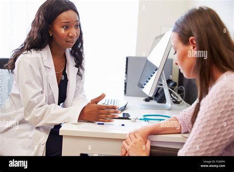 Female Doctor Treating Patient Suffering With Depression Stock Photo
