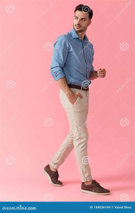 Businessman Walking With Hand In Pocket Looking Over Shoulder Stock