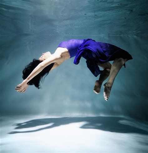 Woman Floating Underwater Side View Photograph By Henrik Sorensen